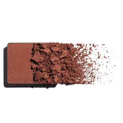 Makeup eyeshadow refill with clay pink powder on a white background