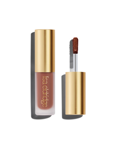 A closed bottle of Lisa Eldridge Liquid Silk Liquid Eyeshadow in deep rosewood Thalia, with a gold cap containing an applicator wand with product on it, against a white background.