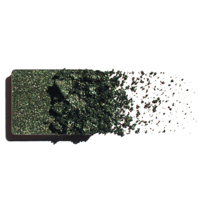 Makeup eyeshadow refill with rich emerald shimmer powder on a white background