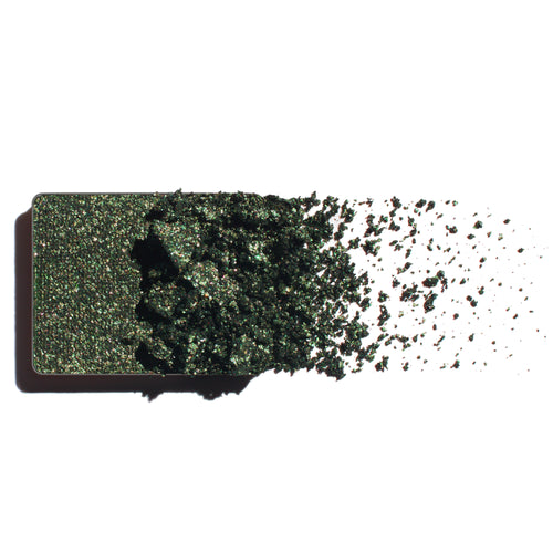 Makeup eyeshadow refill with rich emerald shimmer powder on a white background