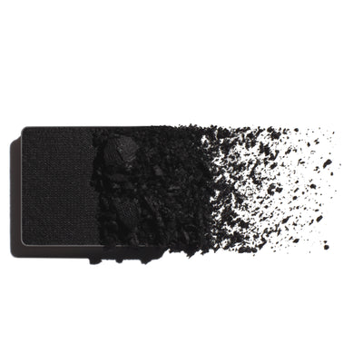Makeup eyeshadow refill with true black powder on a white background