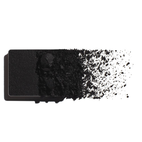 Makeup eyeshadow refill with true black powder on a white background