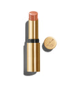 Baume Embrace in Meet Cute, a light peach lip colour, with a gold-colored casing, next to the Lisa Eldridge logo-embossed lid