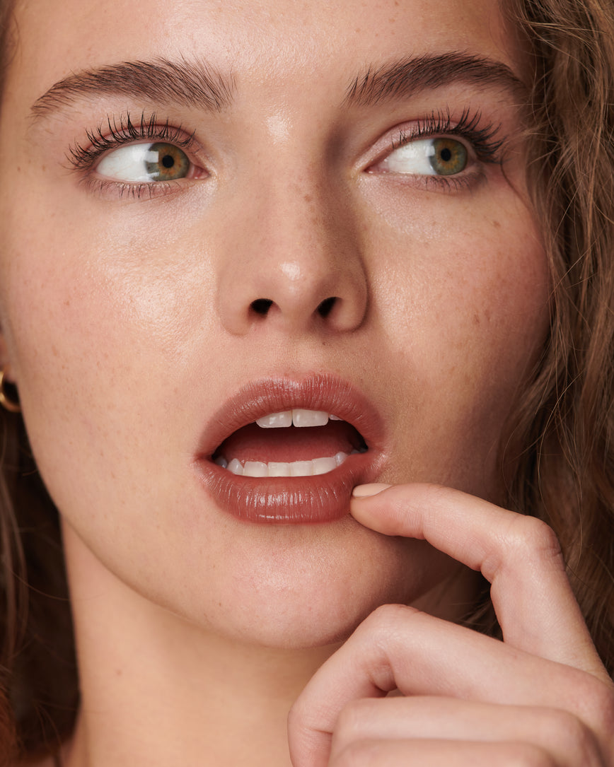 Portrait close-up of model wearing Metropolis Baume Embrace