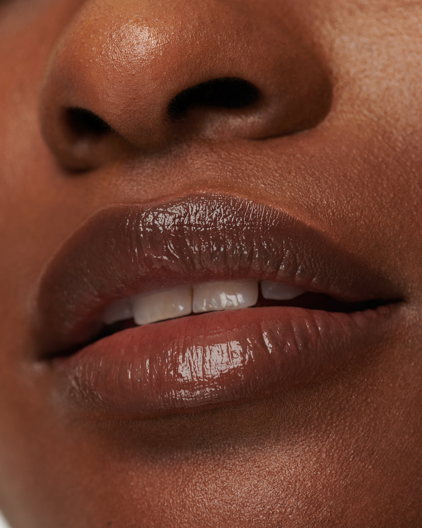 Extreme close up of model's lips, wearing Metropolis Baume Embrace