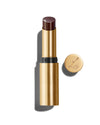 Baume Embrace in Metropolis, a deep blackberry lip colour with a gold-colored casing, next to the Lisa Eldridge logo-embossed lid