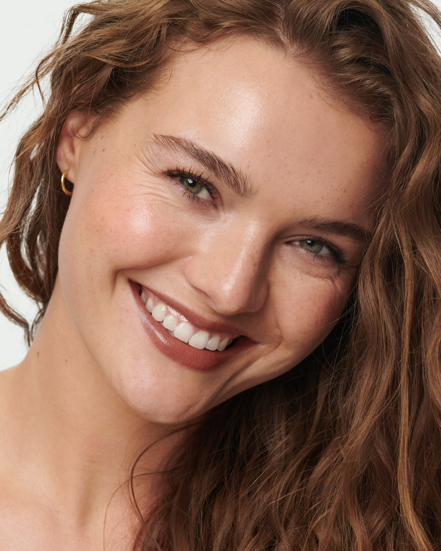 Portrait close-up of model wearing Metropolis Baume Embrace