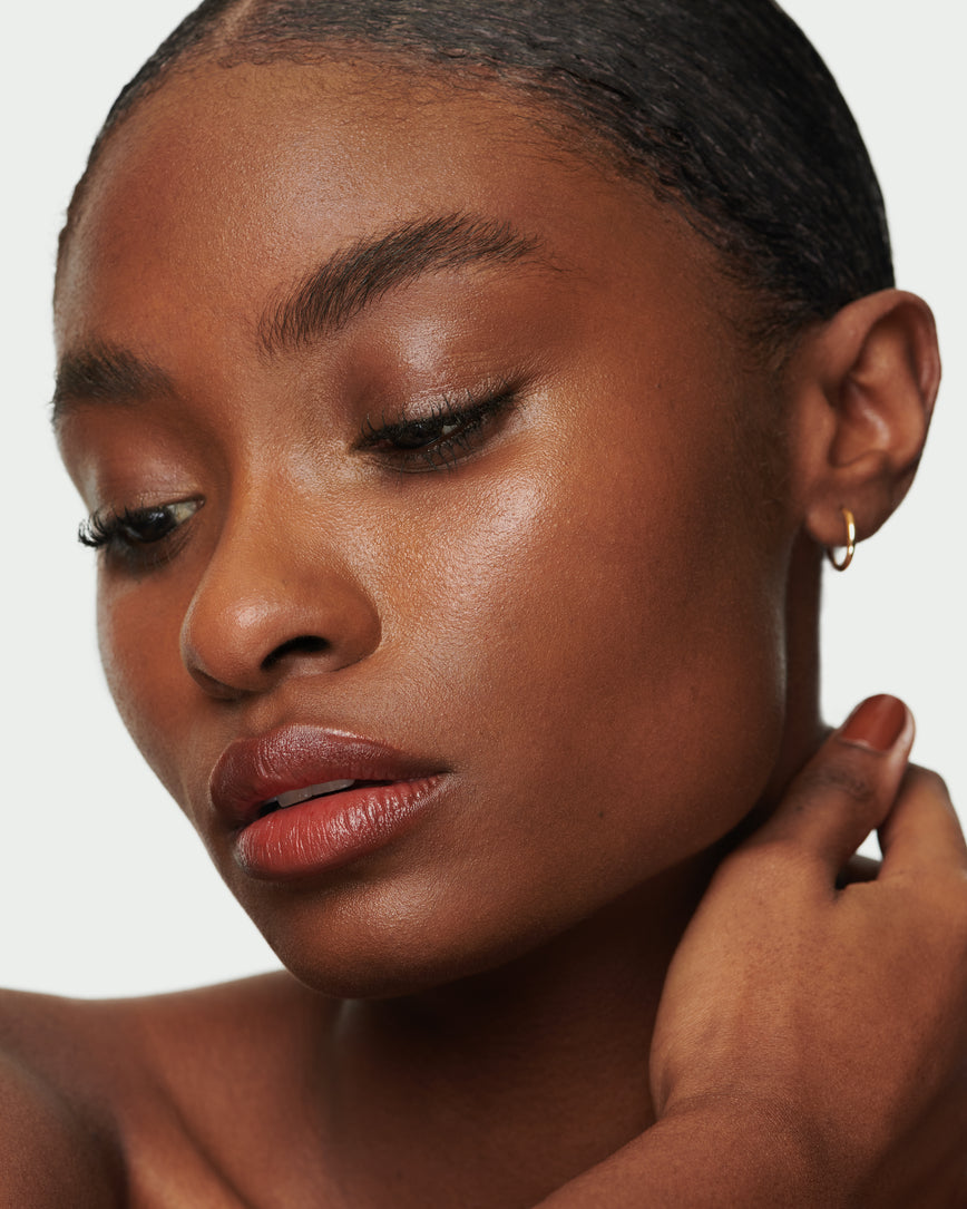 Portrait close-up of model wearing Red Curve Baume Embrace