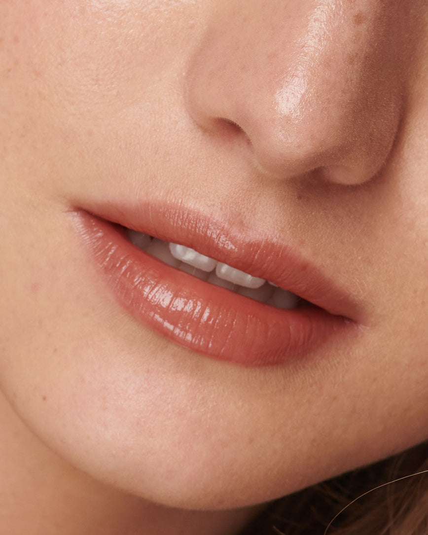 Extreme close up of model's lips, wearing Sweet Fig Baume Embrace