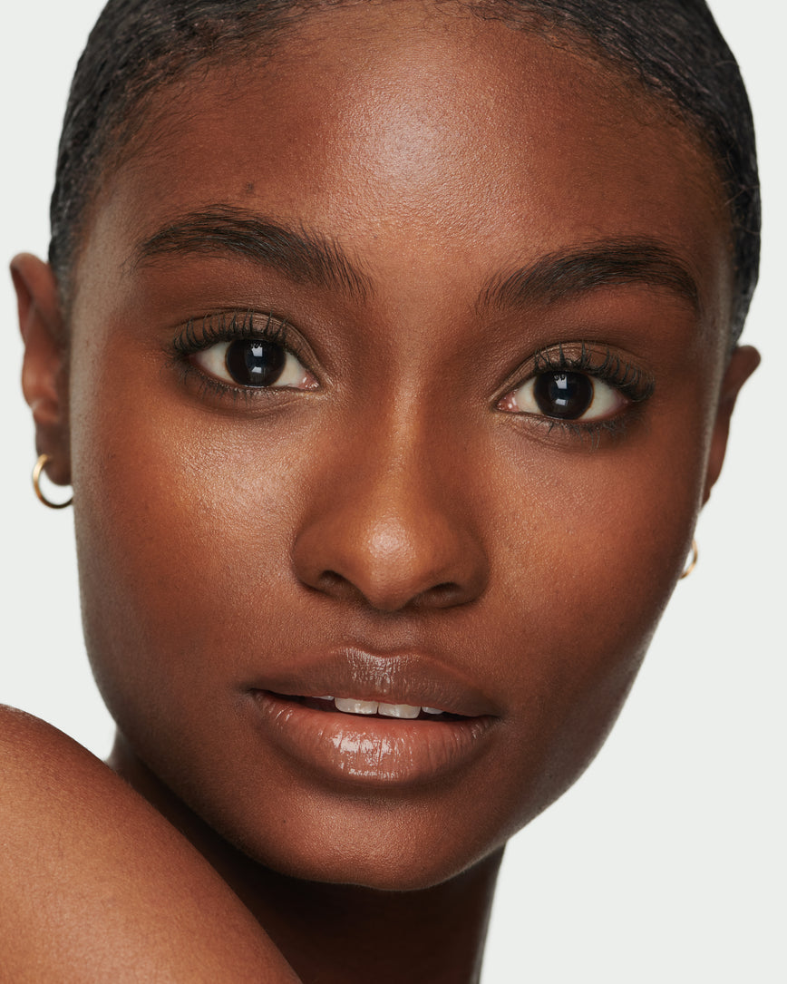 Portrait close-up of model wearing Sweet Fig Baume Embrace