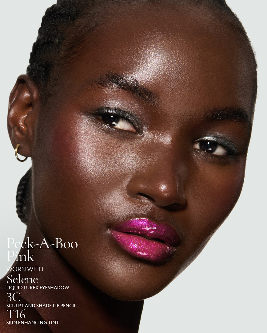Close-up of a model's face against a neutral background, wearing Peek-A-Boo Pink Gloss Embrace Sequin, with Selene Liquid Lurex, 3C Sculpt and Shade Pencil, and T16 Skin Enhancing Tint.