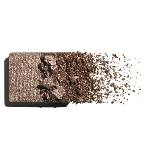 Makeup eyeshadow refill with silvery mink powder on a white background