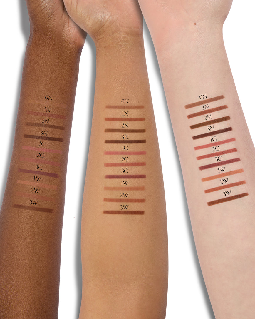 Three model arms of different skin tones with swatches of the Sculpt and Shade Lip Pencil shade range on each arm, displaying how the pencils look on different skin tones and undertones.