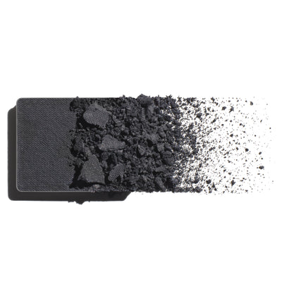 Makeup eyeshadow refill with cool, grey slate powder on a white background