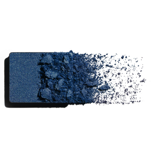 Makeup eyeshadow refill with sapphire blue powder on a white background