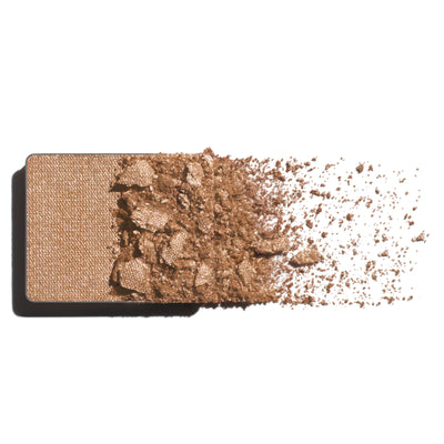 Makeup eyeshadow refill with pearled champagne powder on a white background