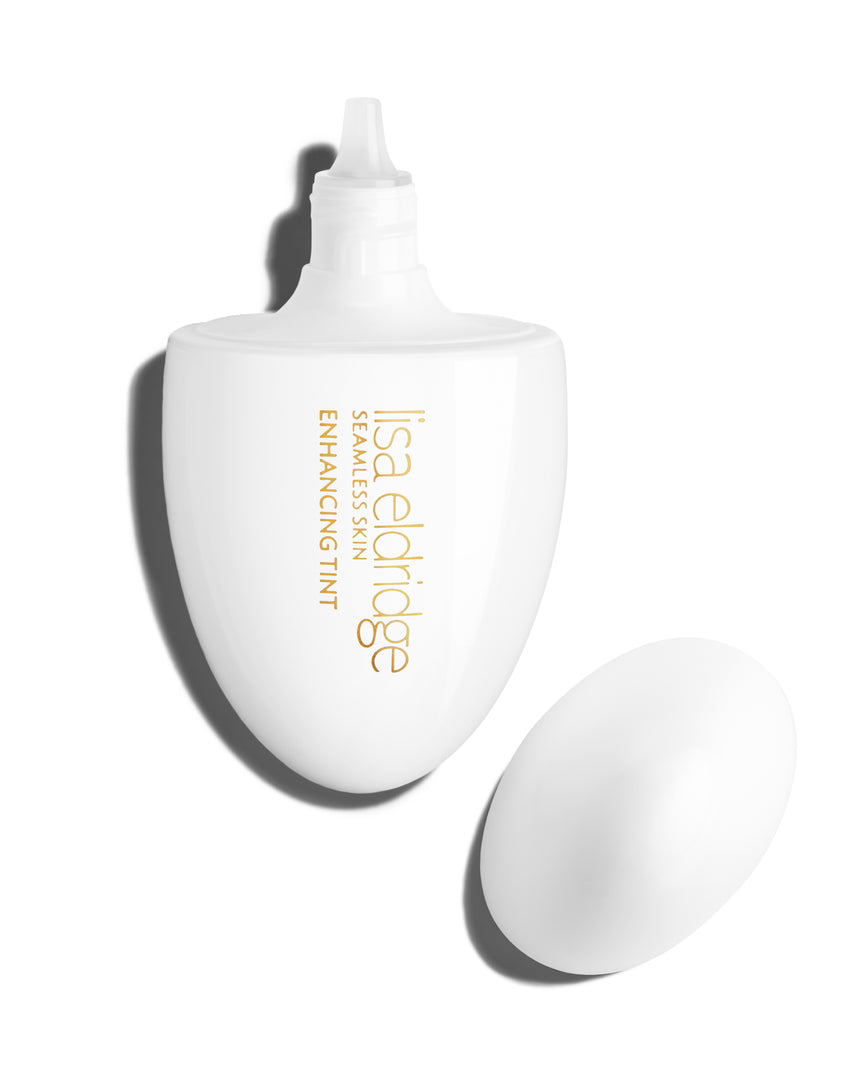 The white pod packaging of Seamless Skin Enhancing Tint by Lisa Eldridge with lid off and dropper shown