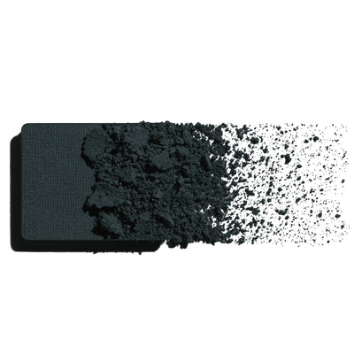 Makeup eyeshadow refill with inky teal powder on a white background